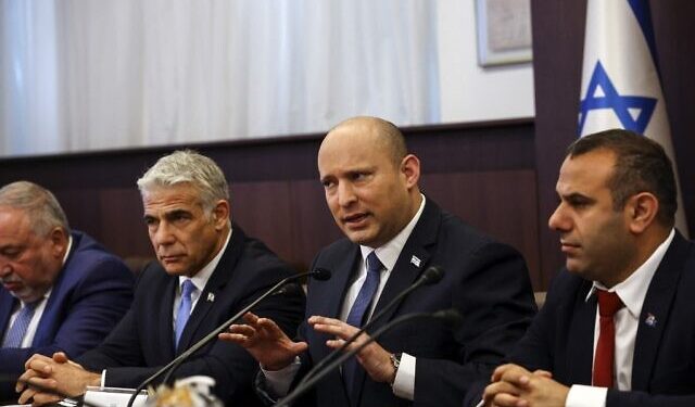 Israeli Prime Minister Naftali Bennett (2-R) and Foreign Minister Yair Lapid (2-L) attend a cabinet meeting at the Prime Minister's office in Jerusalem, on May 22, 2022. (Photo by RONEN ZVULUN / POOL / AFP)