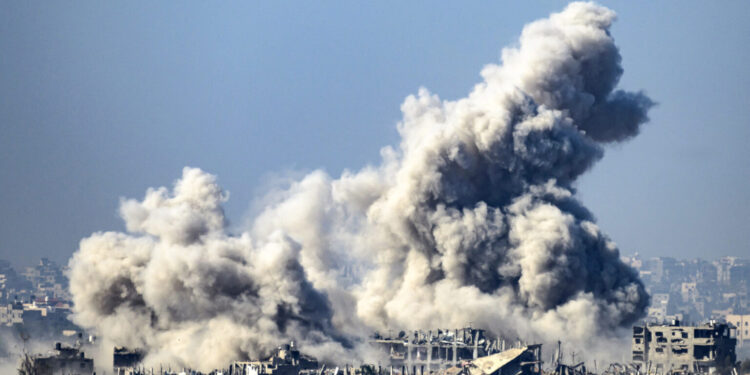 This picture taken from southern Israel near the border with the Gaza Strip shows smoke rising from buildings after being hit by Israeli strikes, as battles resume between Israel and Hamas militants, on December 1, 2023. - A temporary truce between Israel and Hamas expired on December 1, with the Israeli army saying combat operations had resumed, accusing Hamas of violating the operational pause. (Photo by John MACDOUGALL / AFP)